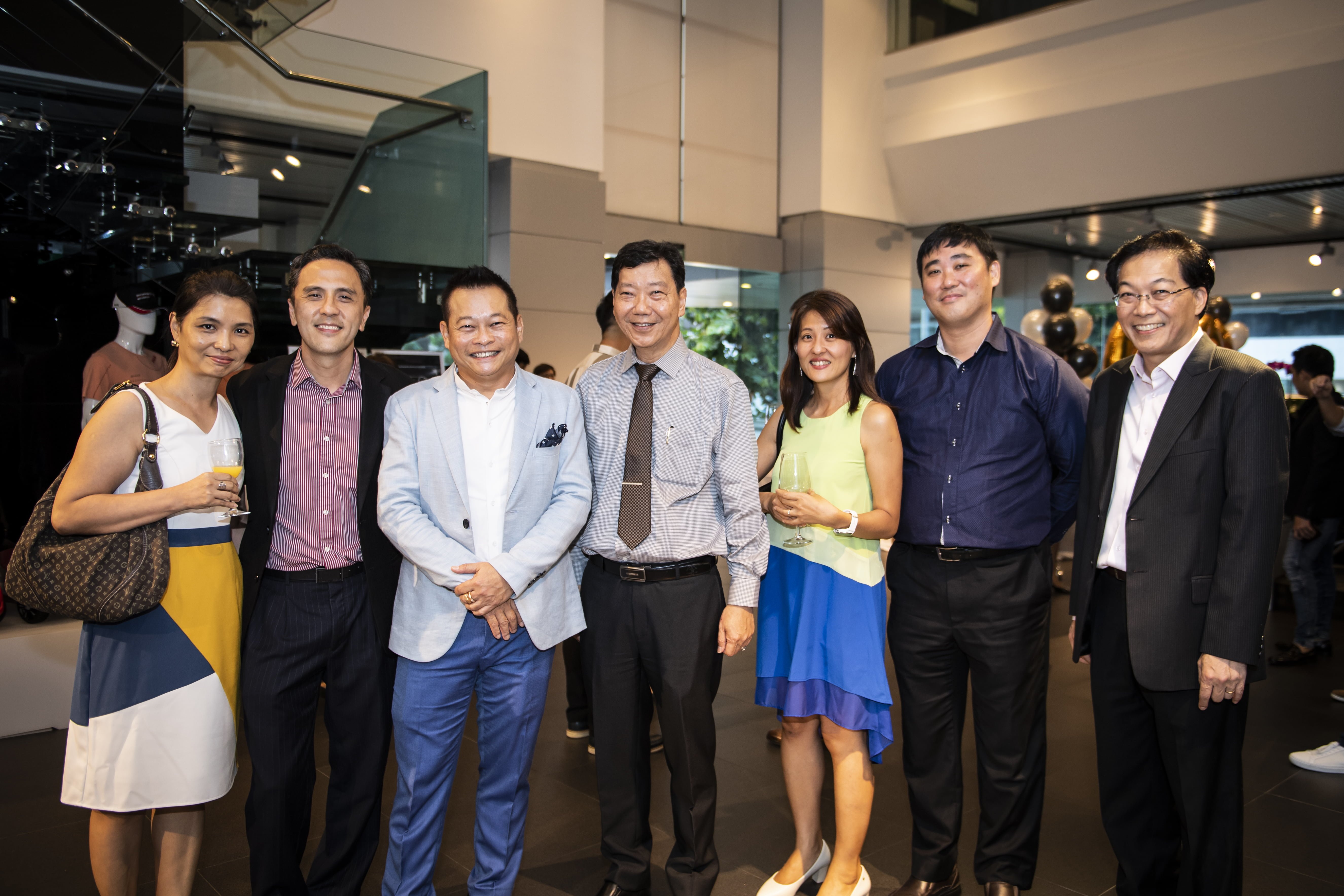 Mr Francis Lee, Managing Director of Stuttgart Auto (centre) and Mr Joe Goh (third from left), together with Porsche guests at the celebratory delivery party held at Porsche Centre Singapore