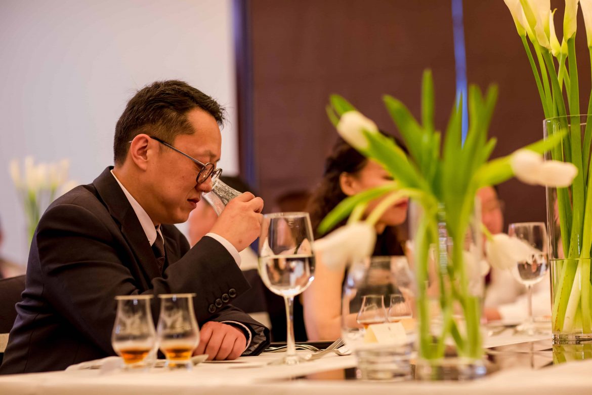 A Rolls-Royce guest enjoying a glass of whisky at the whisky tasting session